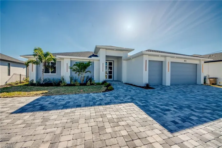 Prairie-style home with a garage and decorative driveway