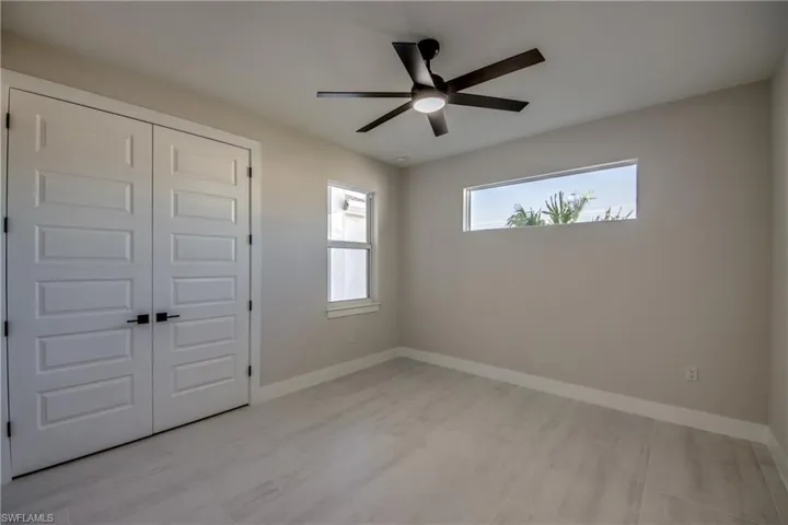 Unfurnished bedroom featuring a closet and a ceiling fan