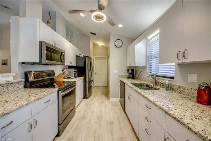 Kitchen looking to garage door entry.