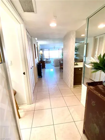Log entry hallway that leads to kItchen and living room.