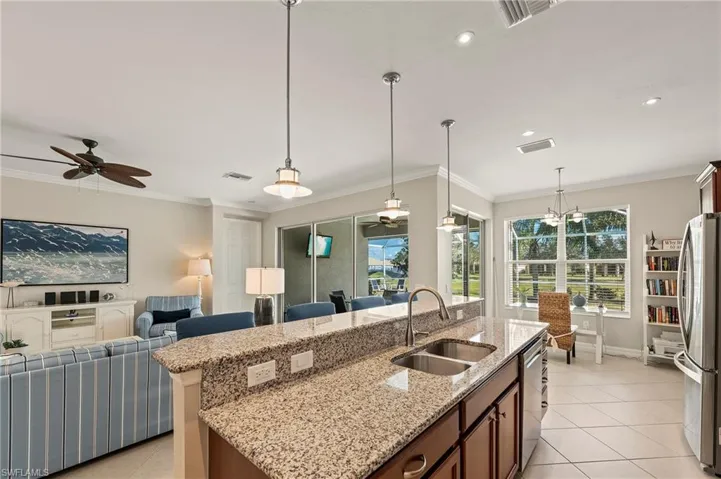 28196 Jewel Fish Ln Bonita Springs FL 34135 - Kitchen island highlighted by pendant lights