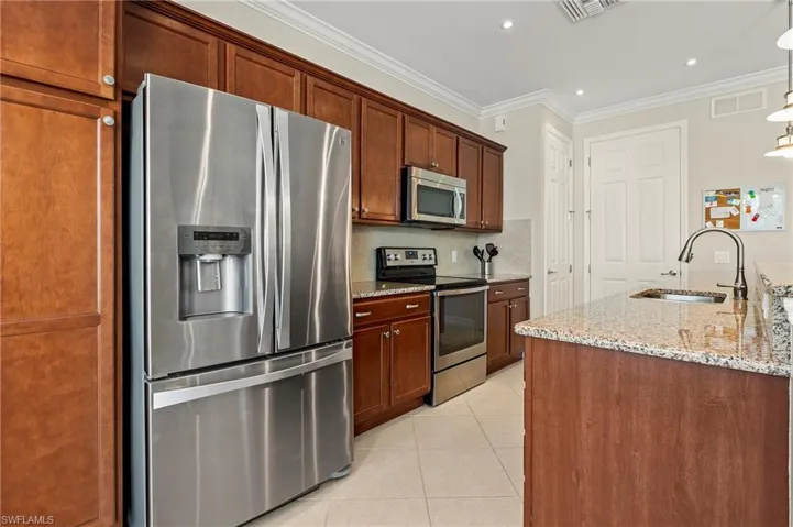 28196 Jewel Fish Ln Bonita Springs FL 34135 - Stainless appliances in kitchen include French door refrigerator