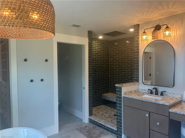 Full bathroom featuring vanity, walk in shower.