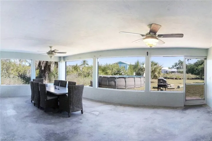 Sunroom / solarium featuring unfinished concrete flooring and plenty of natural light
