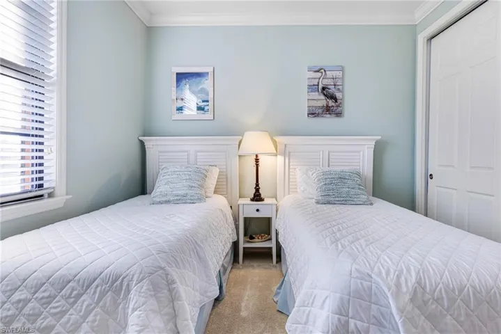 Carpeted bedroom with ornamental molding