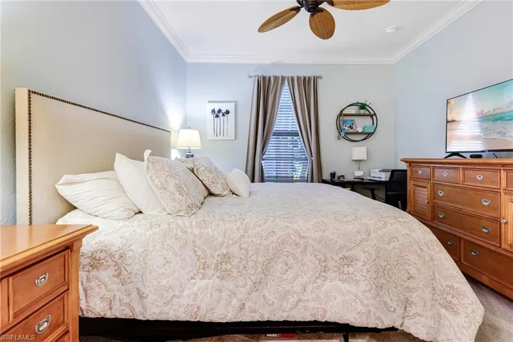 Bedroom featuring ornamental molding and ceiling fan