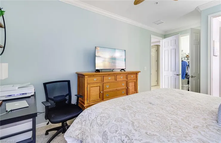 Bedroom featuring crown molding, ceiling fan, and light carpet
