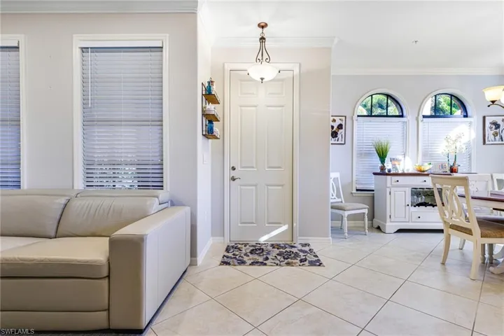 Tiled entrance foyer with crown molding