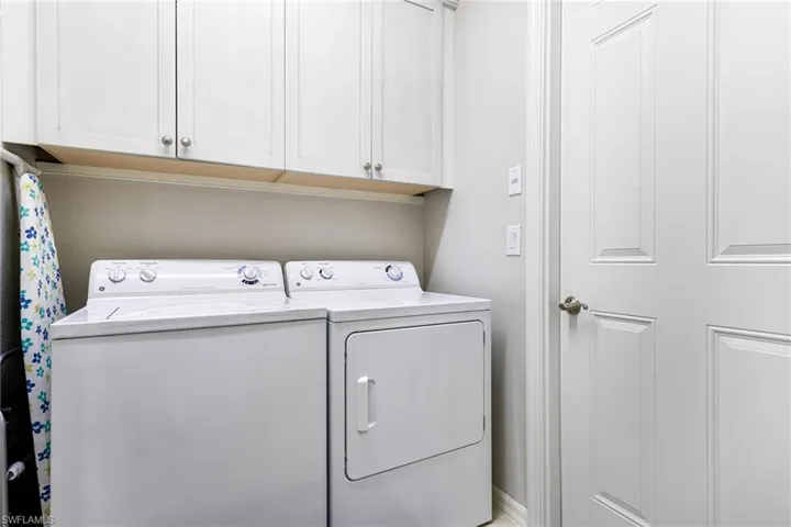 Laundry area with cabinets and washer and clothes dryer