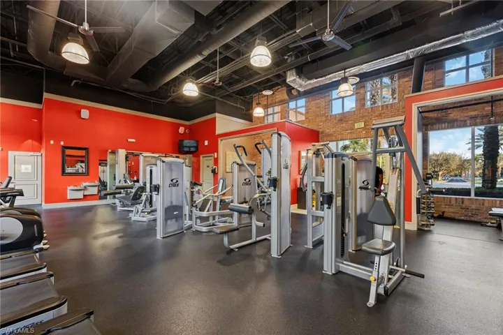 Workout area with brick wall and a high ceiling