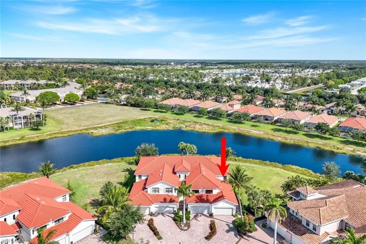 Aerial perspective of suburban area featuring a large body of water