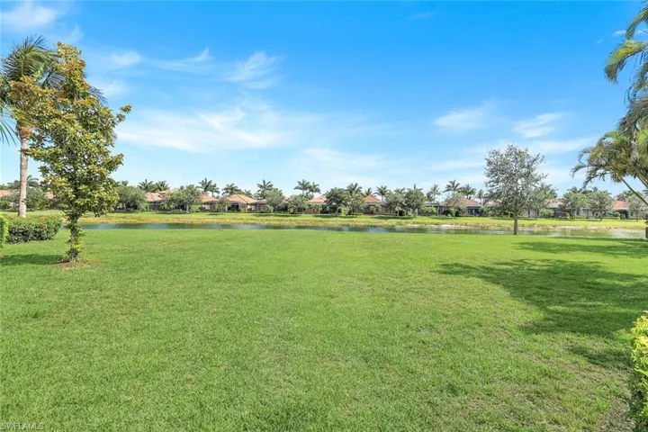 View of grassy yard with a water view and a residential view