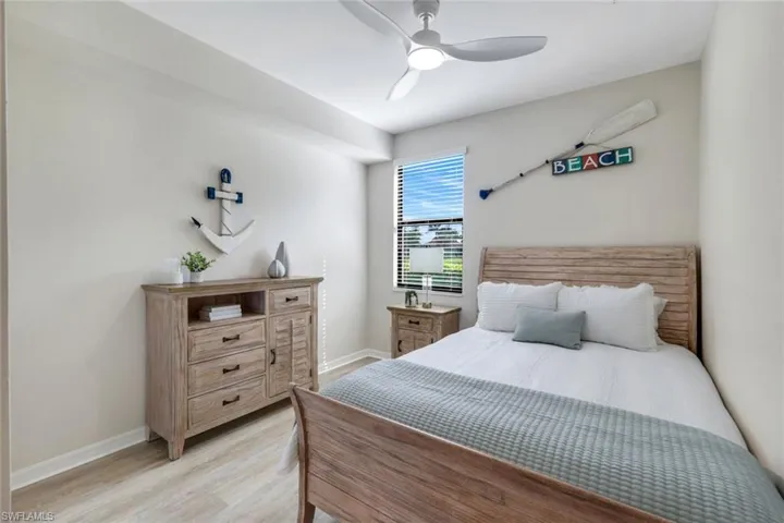 Bedroom with light wood-style floors, baseboards, and a ceiling fan