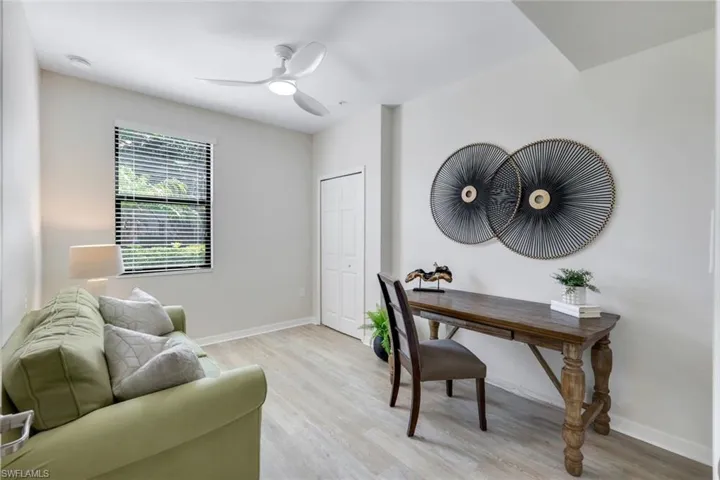 Office with light wood finished floors, baseboards, and a ceiling fan