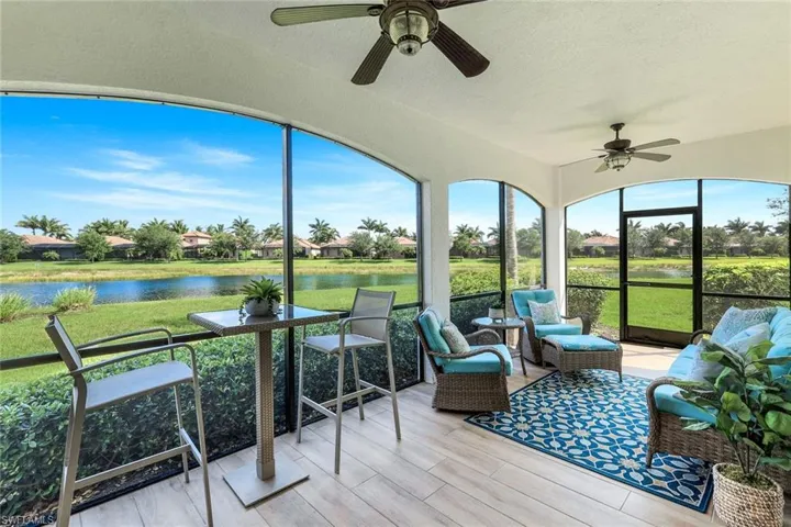 Sunroom featuring ceiling fan, a water view, and an outdoor hangout area