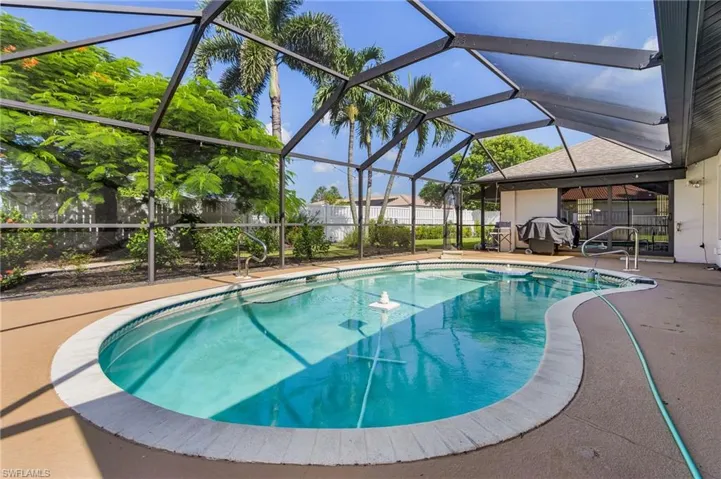 View of pool with a lanai, screen enclosure, and a patio
