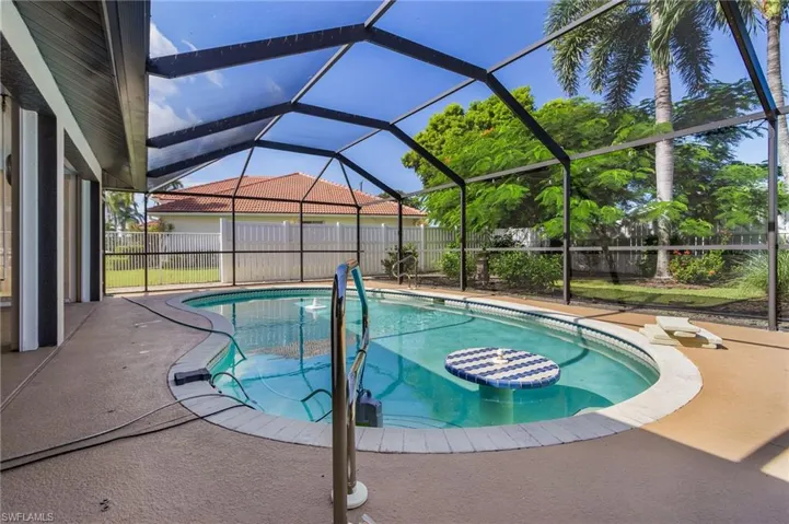 View of  heated swimming pool , swim up table, fountain, sump pump if needed and  under truss lanai