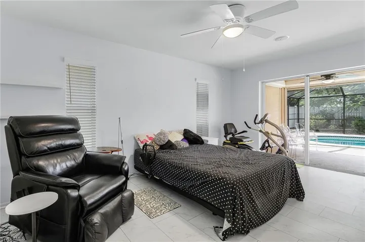 Bedroom with sliders to pool area and a ceiling fan and luxury vinyl plank flooring and extra large room