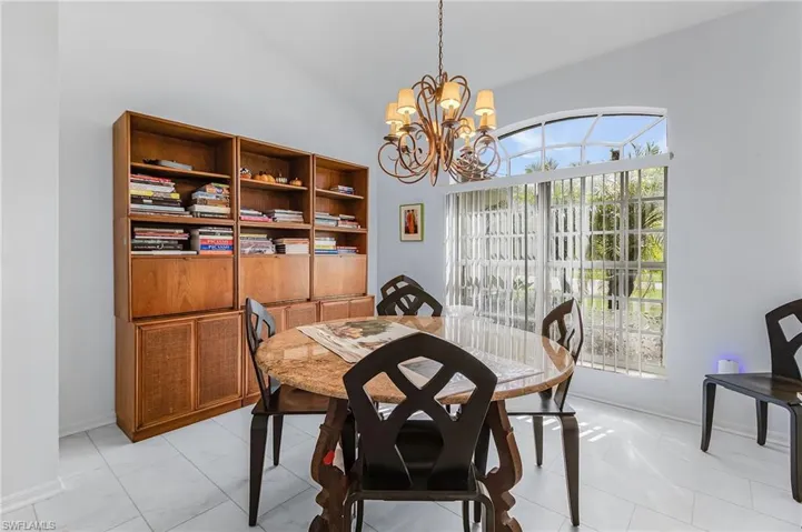 Dining area featuring a chandelier and vaulted ceiling