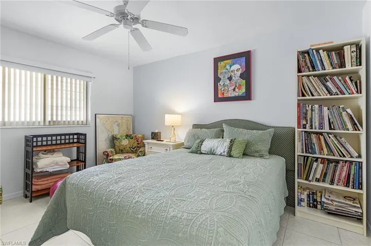 Guest Bedroom #2 featuring light tile patterned flooring and a ceiling fan and double closet