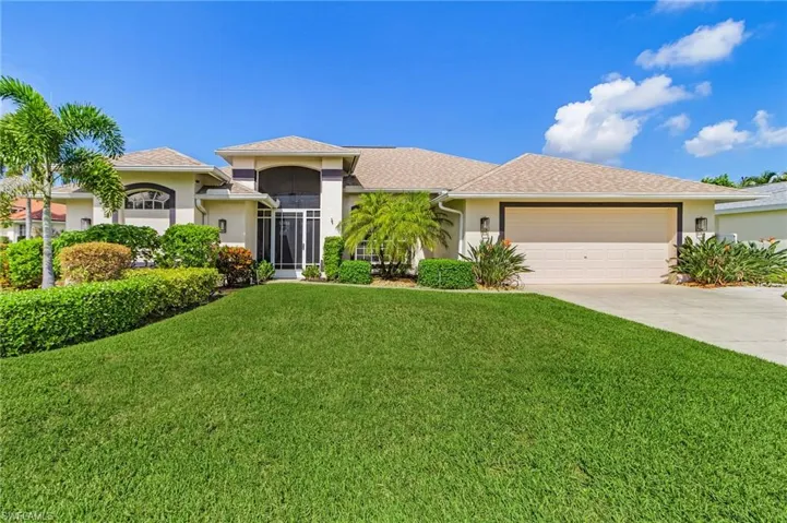 View of front facade featuring stucco siding, a beautifully landscaped front lawn, driveway, an attached garage, and new shingle roof