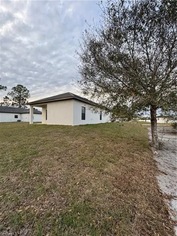 View of property exterior featuring a yard