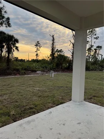 Yard at dusk with a patio area