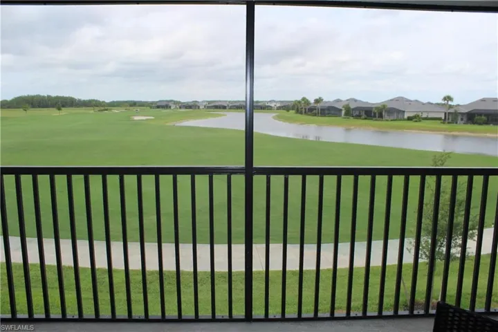 Gate with a water view, a yard, and a residential view