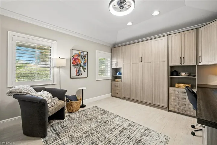 Office featuring crown molding, light wood-type flooring, and recessed lighting