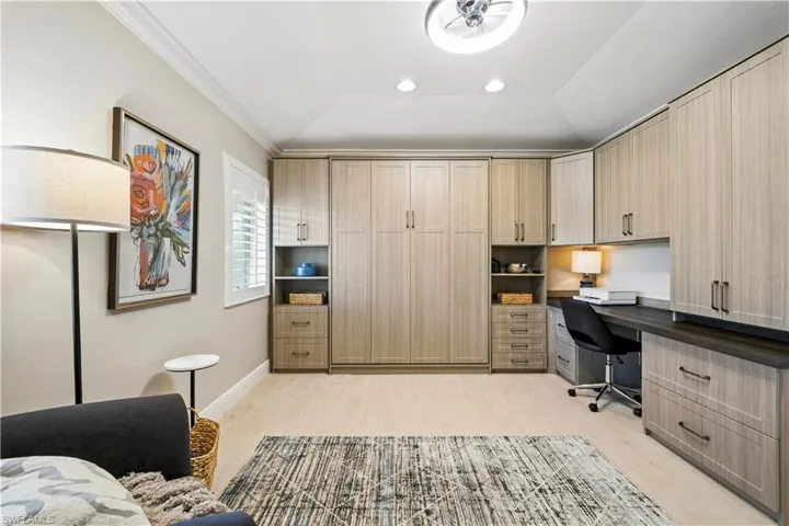 Office area featuring vaulted ceiling, light wood-type flooring, ornamental molding, and recessed lighting