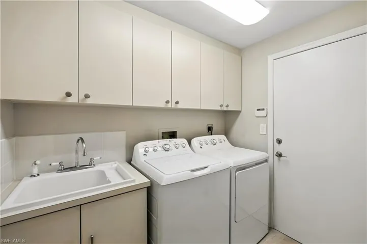 Laundry room featuring cabinet space and washing machine and clothes dryer