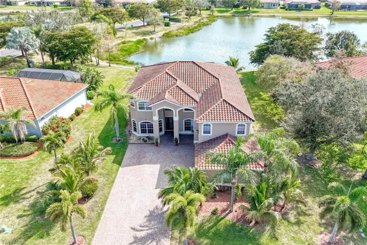 Birds eye view of property with a water view