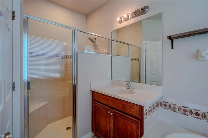 Bathroom with vanity and separate shower and tub