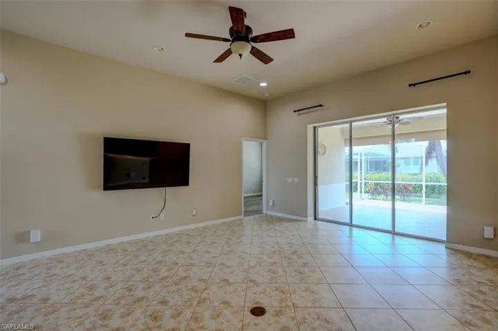 Unfurnished room with ceiling fan and light tile patterned floors