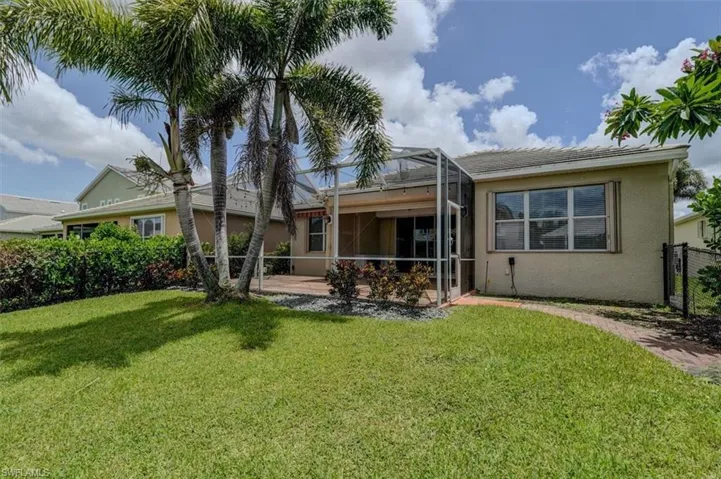 Rear view of property featuring a lawn