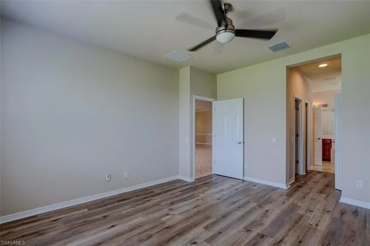 Unfurnished bedroom featuring wood-type flooring and ceiling fan