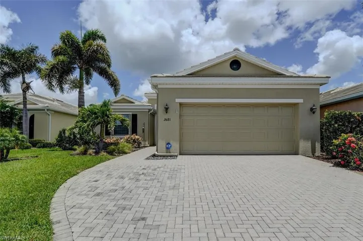 Ranch-style house with a garage and a front yard
