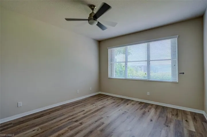 Empty room with ceiling fan and hardwood / wood-style floors