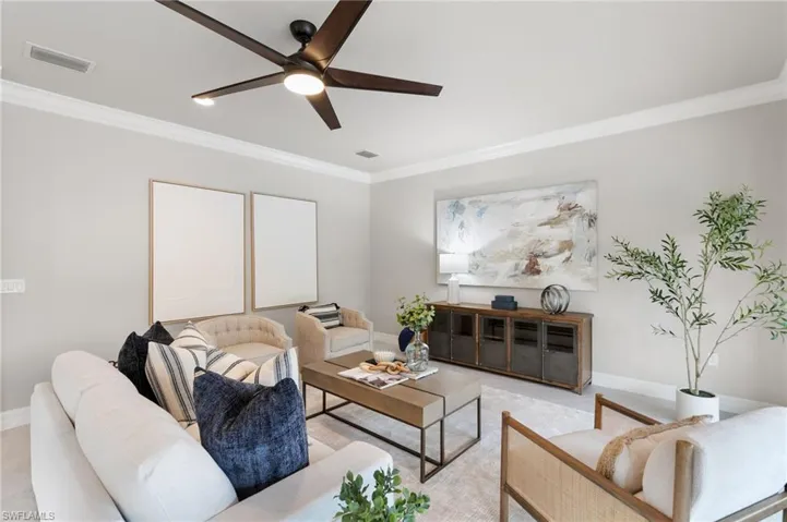 Living room with crown molding and a ceiling fan