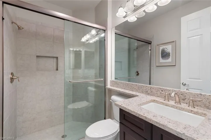 Full bathroom with a shower stall and vanity