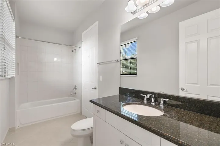Bathroom with  shower combination, vanity, and light tile patterned floors
