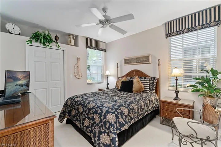 Bedroom with carpet flooring, a closet, and ceiling fan
