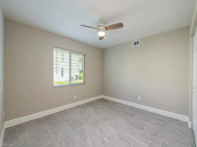 Unfurnished room featuring ceiling fan