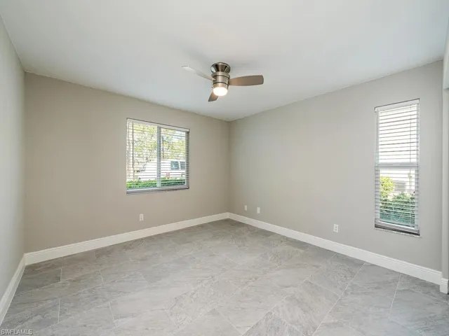Empty room featuring a healthy amount of sunlight and ceiling fan