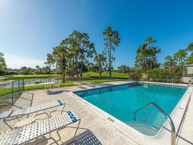 View of pool with a patio and a water view