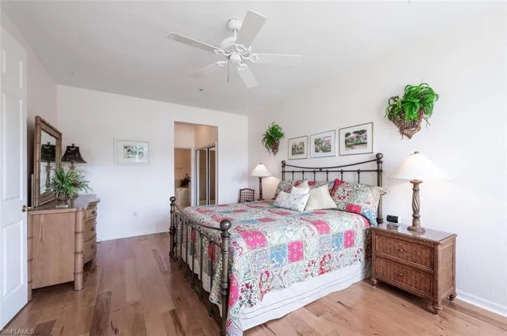 Master Bedroom featuring light wood-style floors, ceiling fan, and baseboards