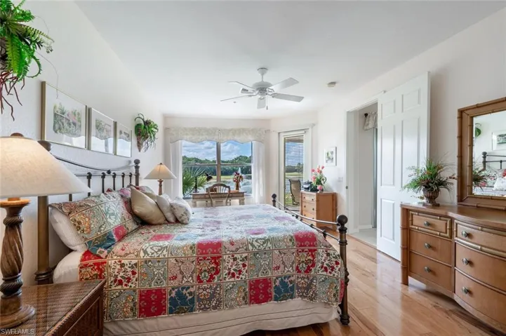 Master Bedroom featuring access to exterior, light wood-type flooring, baseboards, and a ceiling fan