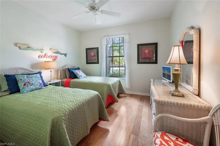 Bedroom featuring light wood-style flooring, ceiling fan, and baseboards