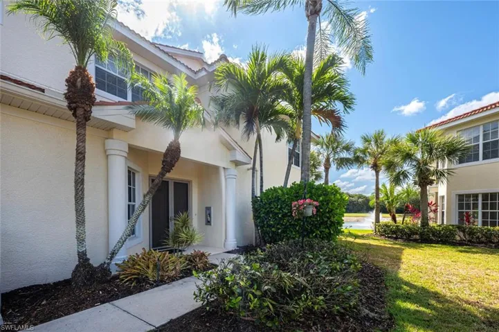 View of property exterior featuring stucco siding and a lawn