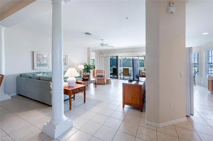 Living room featuring ornate columns, ceiling fan, light tile patterned floors, plenty of natural light, and recessed lighting
